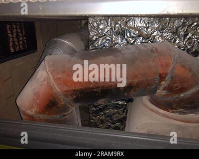 Tuyau de fer chaud rouge fraîchement coulé au poêle en faïence. Banque D'Images