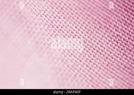 Fond texturé en maille de tissu ramassé dans les détails, gros plan et mise au point sélective. Banque D'Images