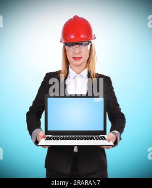 femme ingénieur tenant l'ordinateur portable sur fond bleu Banque D'Images