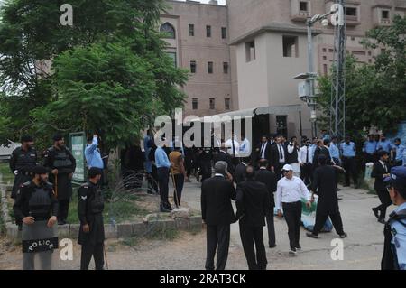 Islamabad, Pakistan. 04 juillet 2023. Le personnel de sécurité muni de boucliers balistiques escorte un véhicule transportant l'ancien Premier ministre pakistanais Imran Khan, alors qu'il arrive devant le tribunal. Khan a régulièrement vu des collaborateurs proches et des membres de son parti Pakistan Tehreek-e-Insaf (PTI) quitter son camp, au milieu d'une crise politique qui s'aggrave depuis plus d'un an. (Photo de Raja Imran Bahadar/Pacific Press) crédit : Pacific Press Media production Corp./Alamy Live News Banque D'Images