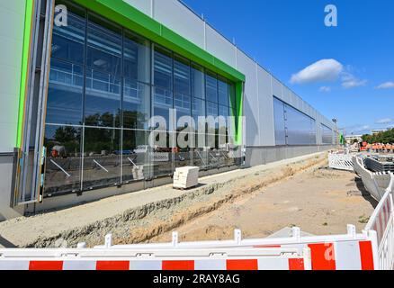 06 juillet 2023, Brandenburg, Cottbus : vue de la façade de 445 mètres de long du nouveau hall sur le chantier de construction de l'usine de maintenance des trains ICE. Deutsche Bahn a commencé la construction de la nouvelle usine ferroviaire de Cottbus en mai 2022. Le premier de ce qui sera plus tard deux ateliers est construit ici. À partir de janvier 2024, les premiers trains ICE 4 d’environ 400 mètres de long seront techniquement entretenus et réparés dans cette salle. Plus de 300 nouveaux employés et stagiaires se sont déjà inscrits pour la future usine DE GLACE. Deutsche Bahn prévoit de créer au total 1 200 postes d ' apprentissage et d ' emploi dans les ' Banque D'Images