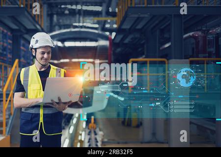 le contrôle masculin de technicien d'opérateur de train d'ingénieur opère l'itinéraire moderne de moniteur de train électrique en ligne avec l'ordinateur portable Banque D'Images