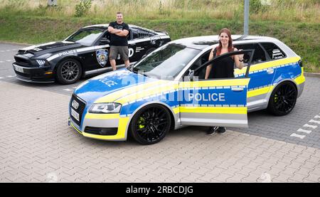 Hanovre, Allemagne. 29 juin 2023. Les tuners automobiles Dennis Klöcker et Svenja Geertz sont debout à côté d'une Mustang qui ressemble à une voiture de police américaine et d'une Audi qui est déjouée de la même manière qu'une voiture de police et porte l'inscription "police". Même sans feux bleus, la voiture de Svenja Geertz ressemble beaucoup à une voiture de patrouille de police classique. Mais comme son Audi dit "police" et non "Polizei", il n'y a pas de problèmes juridiques. (À dpa : tout le monde n'a pas sa propre voiture de police) crédit : Julian Stratenschulte/dpa/Alamy Live News Banque D'Images