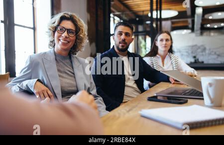 Les gens d'affaires créatifs ayant une réunion sur un projet. Groupe de gens d'affaires ayant une discussion dans une salle de conseil. Équipe de professionnels travaillant t Banque D'Images