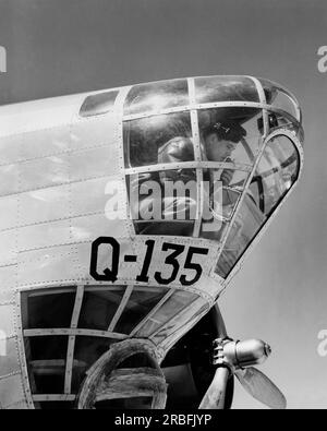 États-Unis : c. 1941 un bombardier de la Force aérienne de la Seconde Guerre mondiale dans le nez de son avion. Banque D'Images