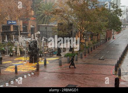 (230710) -- JOHANNESBURG, 10 juillet 2023 (Xinhua) -- Un piéton marche alors que la neige tombe à Melrose Arch à Johannesburg, Afrique du Sud, le 10 juillet 2023. (Xinhua/Zhang Yudong) Banque D'Images