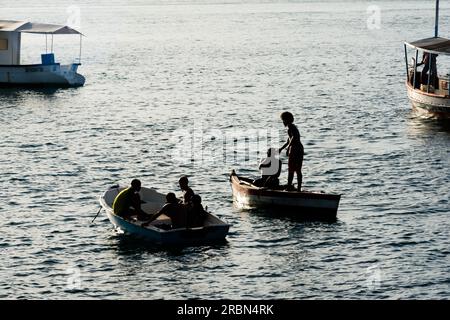 Salvador, Bahia, Brésil - 14 janvier 2022: Les gens, en silhouette, sont vus s'amuser sur les bateaux sur la plage du musée d'art moderne à Salvador, Banque D'Images