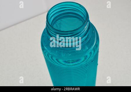Détail d'une bouteille d'eau bleue, le partenaire idéal pour les athlètes qui apprécient une bonne hydratation. Banque D'Images