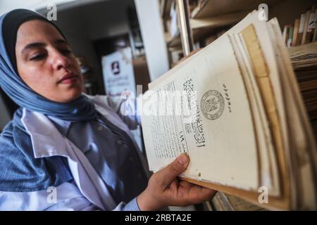 Gaza, Palestine. 10 juillet 2023. Une palestinienne spécialisée dans la conservation, la restauration et la numérisation de manuscrits et de livres rares travaille dans un laboratoire de la Fondation pour les études, la recherche et l'édition à Gaza. Les palestiniennes travaillent à l'archivage et à la restauration de manuscrits et de livres historiques rares anciens dans un laboratoire financé par la British Library de Londres et le Hill Museum. Crédit : SOPA Images Limited/Alamy Live News Banque D'Images