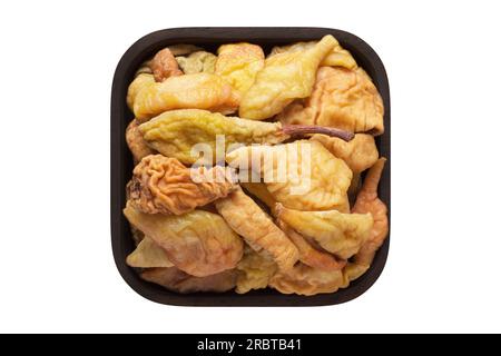 poires séchées dans un bol en bois closeup. nourriture végétarienne isolée sur blanc. Banque D'Images