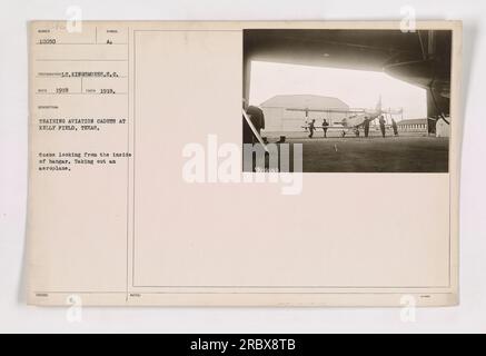 Formation des cadets de l'aviation à Kelly Field, Texas en 1918. Cette photo montre la scène de l'intérieur du hangar alors qu'un avion est sorti. Photographe : Lt. Kingsmore. Source : photographies des activités militaires américaines pendant la première Guerre mondiale.' Banque D'Images