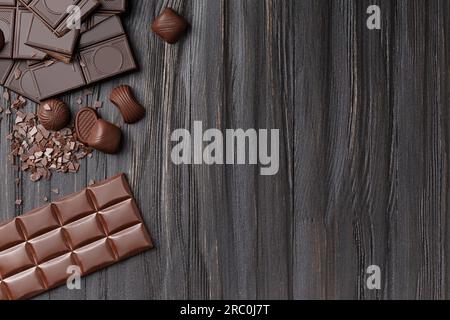 Composition créative de barres de chocolat cassées et entières, chocolats et pépites de chocolat sur une vue de dessus de fond en bois sombre avec espace pour le texte. Banque D'Images