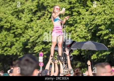 Berlin, Allemagne, 8 juillet 2023, Rave the Planet - une fille debout au-dessus de la foule prenant un selfie Banque D'Images