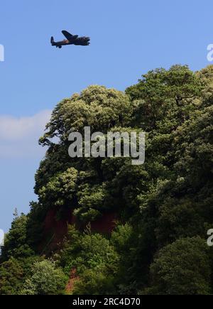 Le vol commémoratif de la bataille d'Angleterre Lancaster survolant le Ness à Shaldon pendant le spectacle aérien de Teignmouth 2023. Banque D'Images