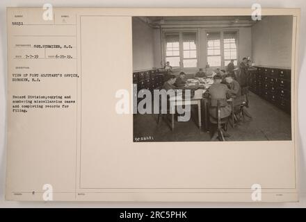 Vue du bureau de Port Adjutant à Hoboken, New Jersey. La photo montre la Division des dossiers, où le personnel est engagé dans la copie et la numérotation des dossiers divers et la rédaction des dossiers pour le classement. Cette image fait partie de la collection numérotée 58531 et a été prise par le photographe S.C. Stemizer le 25 juin 1919. Banque D'Images