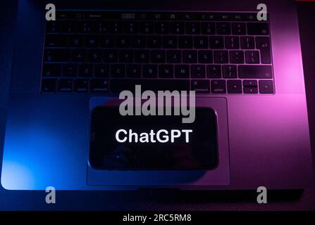 Açores, Portugal - 21.01.2023 : smartphone sur le dessus du clavier de l'ordinateur portable avec le nom du logo ChatGPT sur l'écran. Banque D'Images