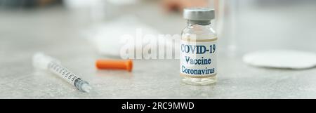 Vaccin contre le coronavirus et seringue médicale sur la table en clinique Banque D'Images