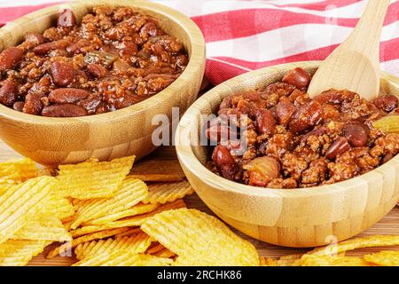 Un bol en bois de délicieux Chili avec des frites Banque D'Images