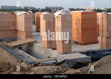 Chantier de construction avec de nouveaux murs de cloisonnement en blocs de briques thermo. Matériau de construction Thermo Bricks céramique argile rouge. une maison privée sur le o Banque D'Images