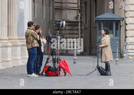 Une équipe italienne de téléfilms commence à filmer un reportage à l'extérieur de la Piazza Colonna, Rome, entre averses de pluie, avril 2023. Banque D'Images