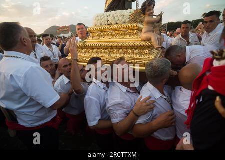 Malaga, Espagne. 16 juillet 2023. Les pénitents de la fraternité 'Virgen del Carmen' sont vus portant la statue de la vierge sur la plage alors qu'ils prennent part à une procession dans le quartier 'El Palo'. Chaque année, le 16 juillet, la ville de Malaga célèbre une fête religieuse en l'honneur de la 'Virgen del Carmen', patron des marins et des pêcheurs. La statue de la Vierge, portée par un groupe de croyants en costume traditionnel le long des rues, est placée sur un bateau de la plage, qui plus tard navigue le long de la côte de Malaga. (Photo Jesus Merida/SOPA Images/Sipa USA) crédit : SIPA USA/Alamy Live News Banque D'Images