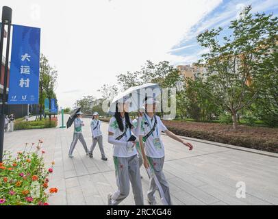 Chengdu, province chinoise du Sichuan. 15 juillet 2023. Des volontaires marchent dans le village des Universiades, Chengdu, dans la province du Sichuan, dans le sud-ouest de la Chine, le 15 juillet 2023. Crédit : Wang Xi/Xinhua/Alamy Live News Banque D'Images