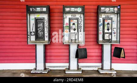 HAMPTON, NEW HAMPSHIR, États-Unis - 15 JUILLET 2023 : trois stand de téléphone rétro à la mode ancienne dans le New Hampshire Front célèbre Liquor and Wine Outlet Banque D'Images