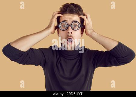 Étudiant drôle paniquant et regardant la caméra avec une expression de visage effrayé choqué Banque D'Images