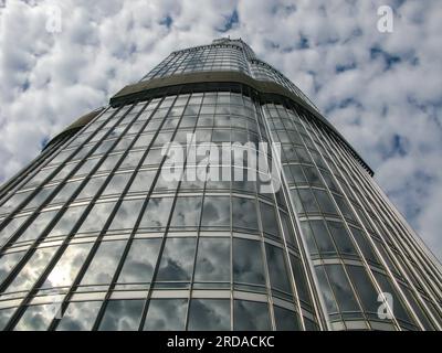 view of the burj khalifa from the observation platform on a background of blue sky with clouds reflected in the glass windows of a skyscraper, Dubai, Stock Photo