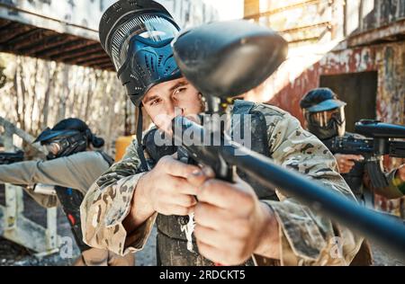 Équipe de paintball, arme et homme viser, se concentrer ou tirer sur la cible, la compétition ou le conflit de champ de bataille, combat ou mission. Groupe militaire, jeu de passe-temps ou Banque D'Images