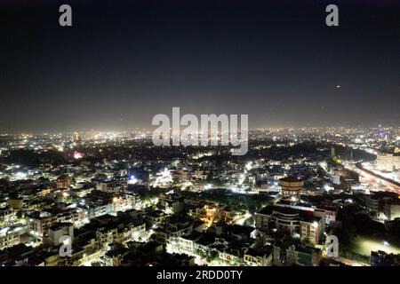 trépied de drone aérien montrant le paysage urbain de jaipur delhi avec des feux d'artifice, des fusées, des pyrotechniques et des lanternes de ciel la nuit pour célébrer makar Banque D'Images