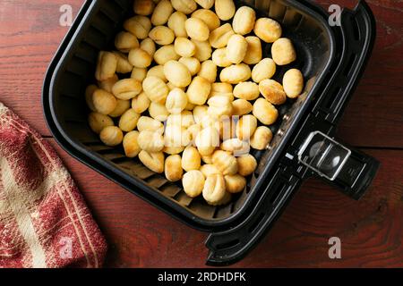 Gnocchi dans un panier de friteuse pneumatique. Banque D'Images