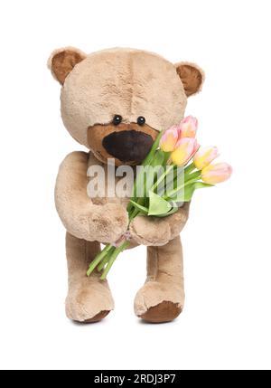 Mignon ours en peluche avec de belles tulipes isolé sur blanc Banque D'Images