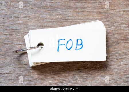 Carte Flash avec écriture manuscrite en mot FOB (abréviation de Free On Board) sur fond de bois Banque D'Images