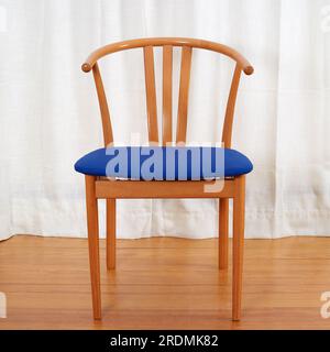 Trois chaises en bois minimalistes modernes du milieu du siècle avec sièges bleus. chaises de style wishbone des années 1960. Banque D'Images