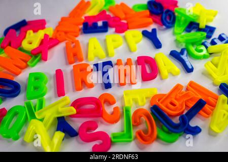 A close-up of the words "Happy Birthday" made from colorful letter magnets Banque D'Images