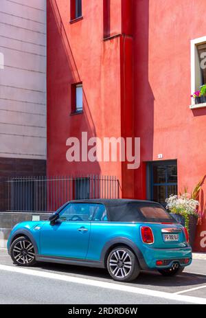 Bleu Aqua Mini Cooper devant immeuble rouge rue Alfred de Vigny - Loches, Indre-et-Loire (37), France. Banque D'Images