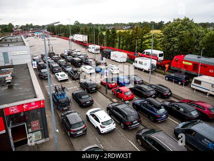 23 juillet 2023, Schleswig-Holstein, Niebüll : les voitures font la queue à la station de chargement de Niebüll pour la navette Deutsche Bahn Sylt, attendant de monter à bord du train. Photo : Daniel Bockwoldt/dpa Banque D'Images