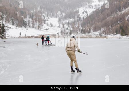 Villar Saint Pancrace (sud-est de la France) : patinage sur glace sur un lac gelé en hiver. Des gens jouant au hockey sur glace sur le lac gelé Orceyrette. Jeune m Banque D'Images