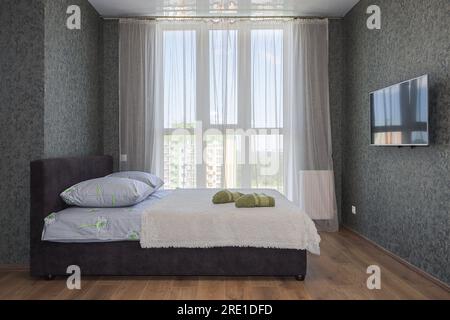 Lit double près de la fenêtre dans l'intérieur de la chambre Banque D'Images
