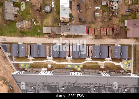 Photographie par drone du nouveau complexe d'appartements et des vieilles maisons dans une ville pendant la journée d'été Banque D'Images