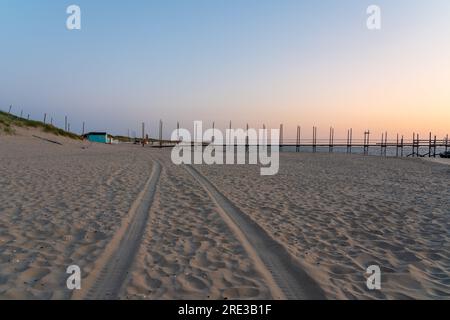 Au lever du soleil, cette belle jetée en bois se dresse sur la plage dans la mer Banque D'Images