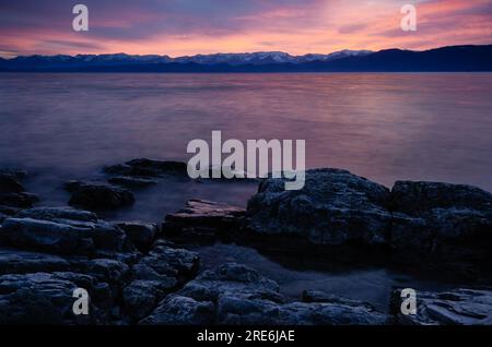 Sunrise peint le ciel au-dessus du lac Flathead et de la chaîne Swan Range, West Shore State Park, Montana, États-Unis Banque D'Images