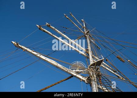 Le mât principal et les cours d'un voilier classique romantique, les haubans visibles, les haubans, le nid de mât et le gréement complexe, ciel bleu en arrière-plan. Banque D'Images