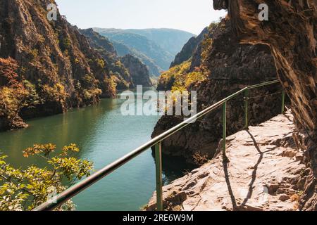 Une passerelle avec un garde-corps le long de la paroi du canyon de Matka gorge en Macédoine du Nord Banque D'Images