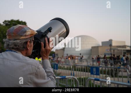 Madrid, Espagne. 25 juillet 2023. Un homme observe la lune à travers un télescope. Le Planétarium de Madrid, en collaboration avec AIRBUS, l’Association astronomique de Madrid (AAM) et l’Agence spatiale européenne (ESA), a organisé une nuit d’observation avec télescopes pour commémorer le 54e anniversaire de l’arrivée des humains sur la Lune. Crédit : Marcos del Mazo/Alamy Live News Banque D'Images