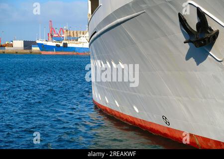 Côté proue tribord d'un navire blanc, avec ancre noire et eau de mercerie bleue. Banque D'Images