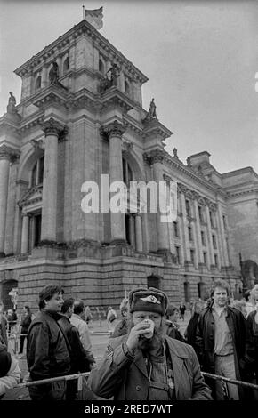 RDA, Berlin, 22.02.1990, stands de souvenirs, homme avec NVA Tschapka, battage mural au Reichstag, [traduction automatique] Banque D'Images