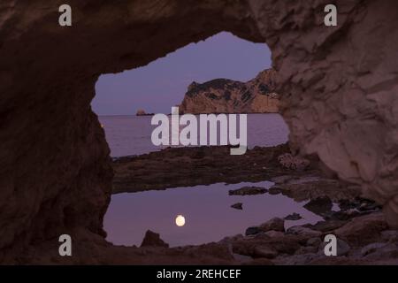 Pleine lune à Cala Blanca à Javea. Vue du Cap Prim. Banque D'Images