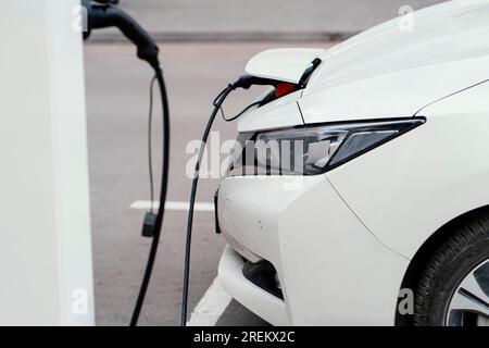 Véhicule à vue latérale avec station de charge pour véhicule électrique. Belle photo Banque D'Images